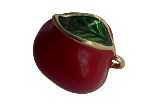 Glossy red apple charm with a green leaf gem and gold trim