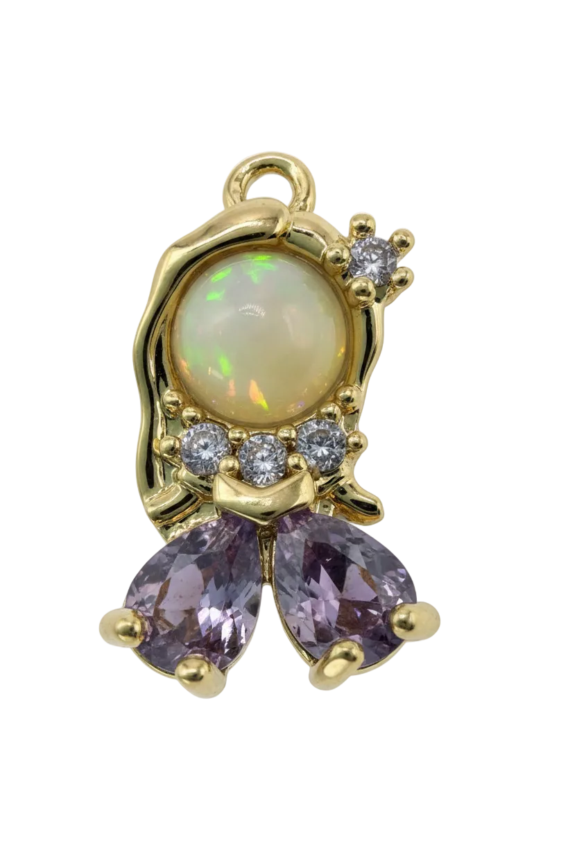 Gold butterfly with opalescent oval center, purple pear-cut stones, and clear crystal accents