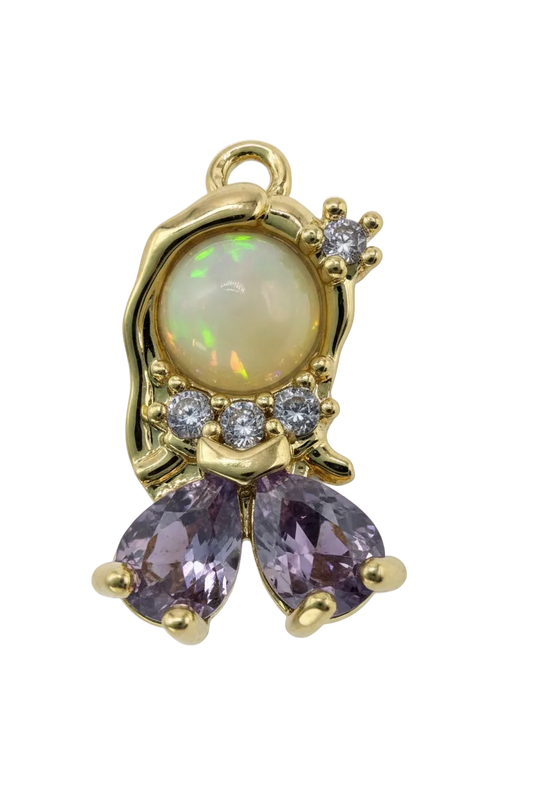 Gold butterfly with opalescent oval center, purple pear-cut stones, and clear crystal accents