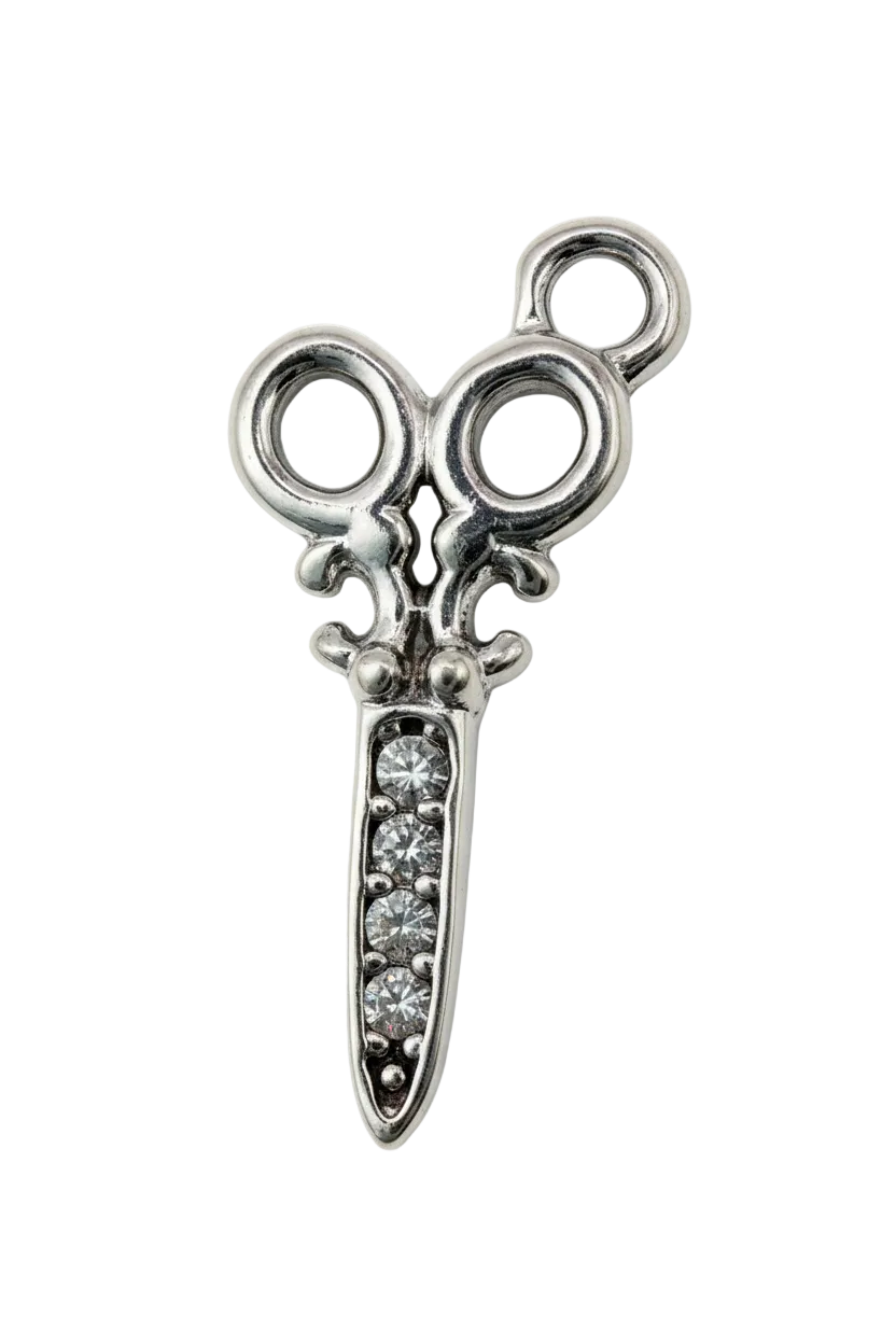Polished silver scissors motif with clear crystal accents on the blade