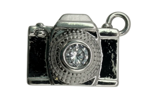 Polished silver camera charm with a clear faceted crystal lens on black background