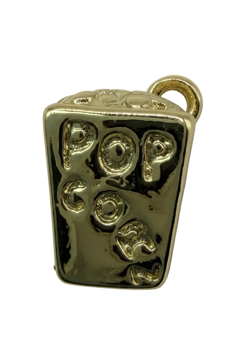 Glossy gold rectangular candy bar charm with raised gummy-like shapes and darkened recessed details