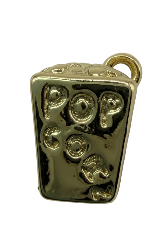 Glossy gold rectangular candy bar charm with raised gummy-like shapes and darkened recessed details