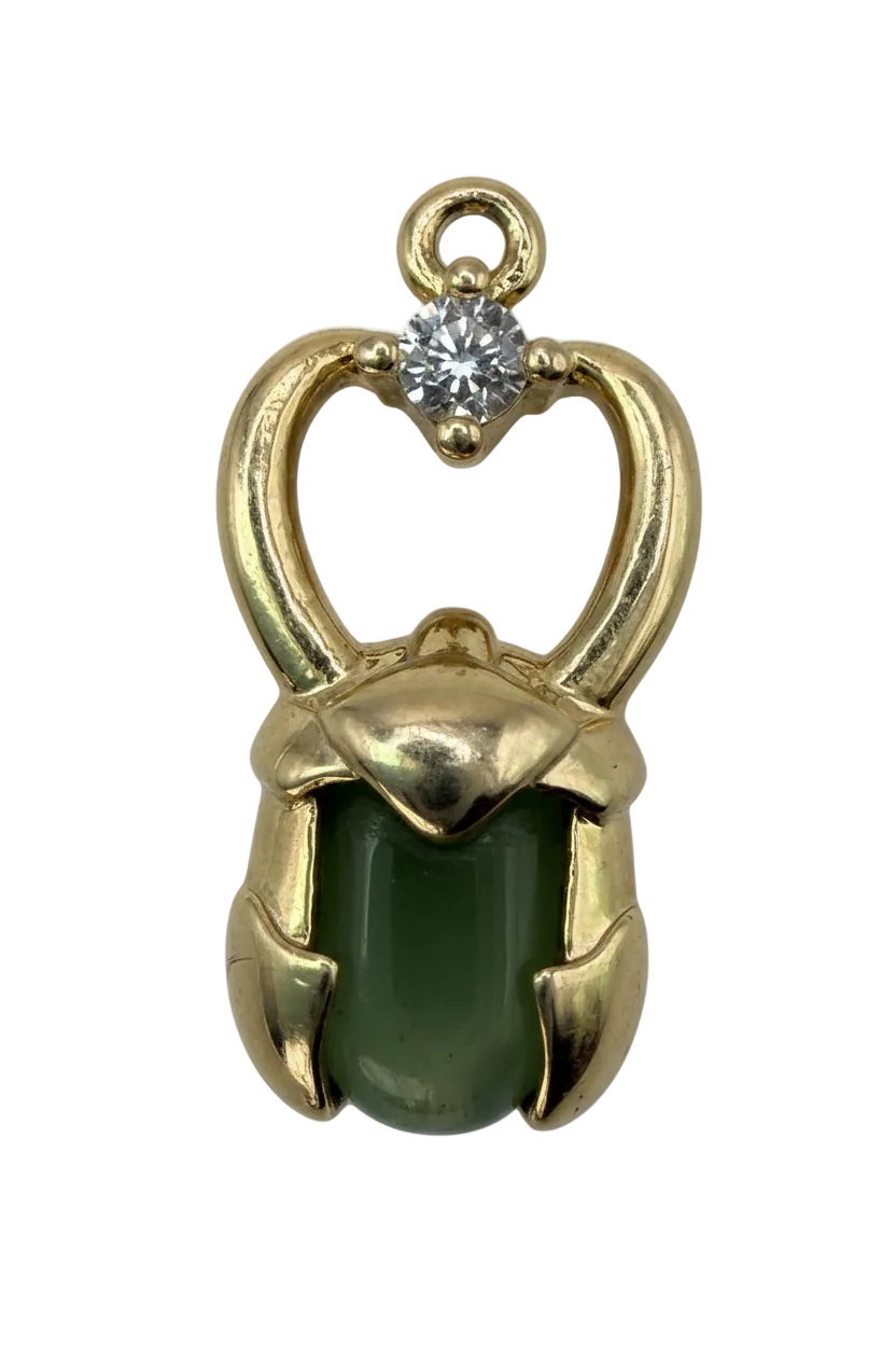 Gold charm featuring a green cat-eye cushion stone with a small clear crystal accent