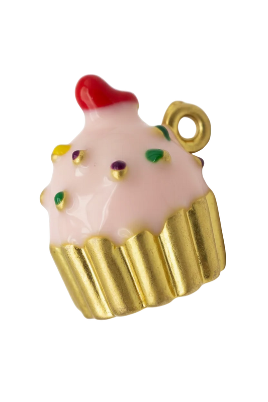 Gold cupcake with pink frosting, multicolor sprinkles, and red cherry top