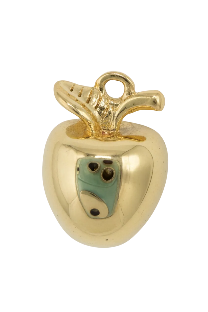 Gold and ivory tooth figure with a small green face detail and glossy finish