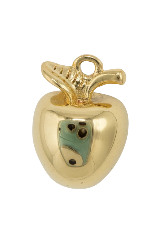 Gold and ivory tooth figure with a small green face detail and glossy finish