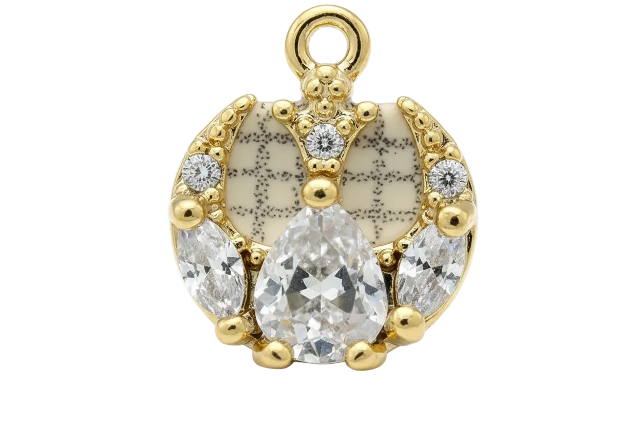 Gold horseshoe charm with ivory speckled enamel and clear faceted crystals