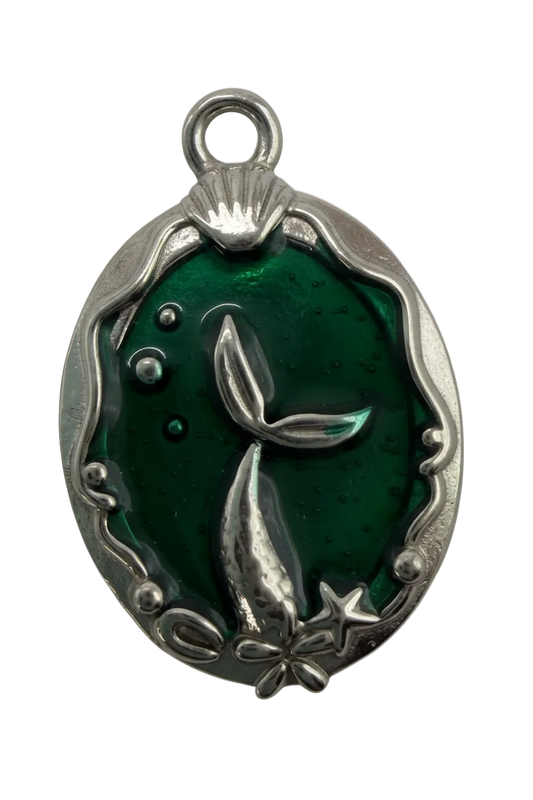 Emerald green translucent oval charm with silver whale tail, star, and comet details