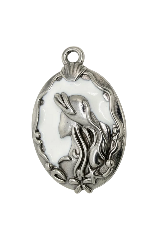 Oval silver medallion with white enamel and raised bird with floral vine details