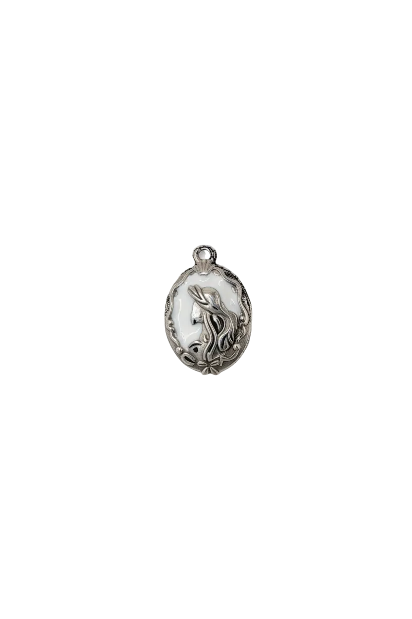 Silver oval medallion with white enamel and raised bird motif
