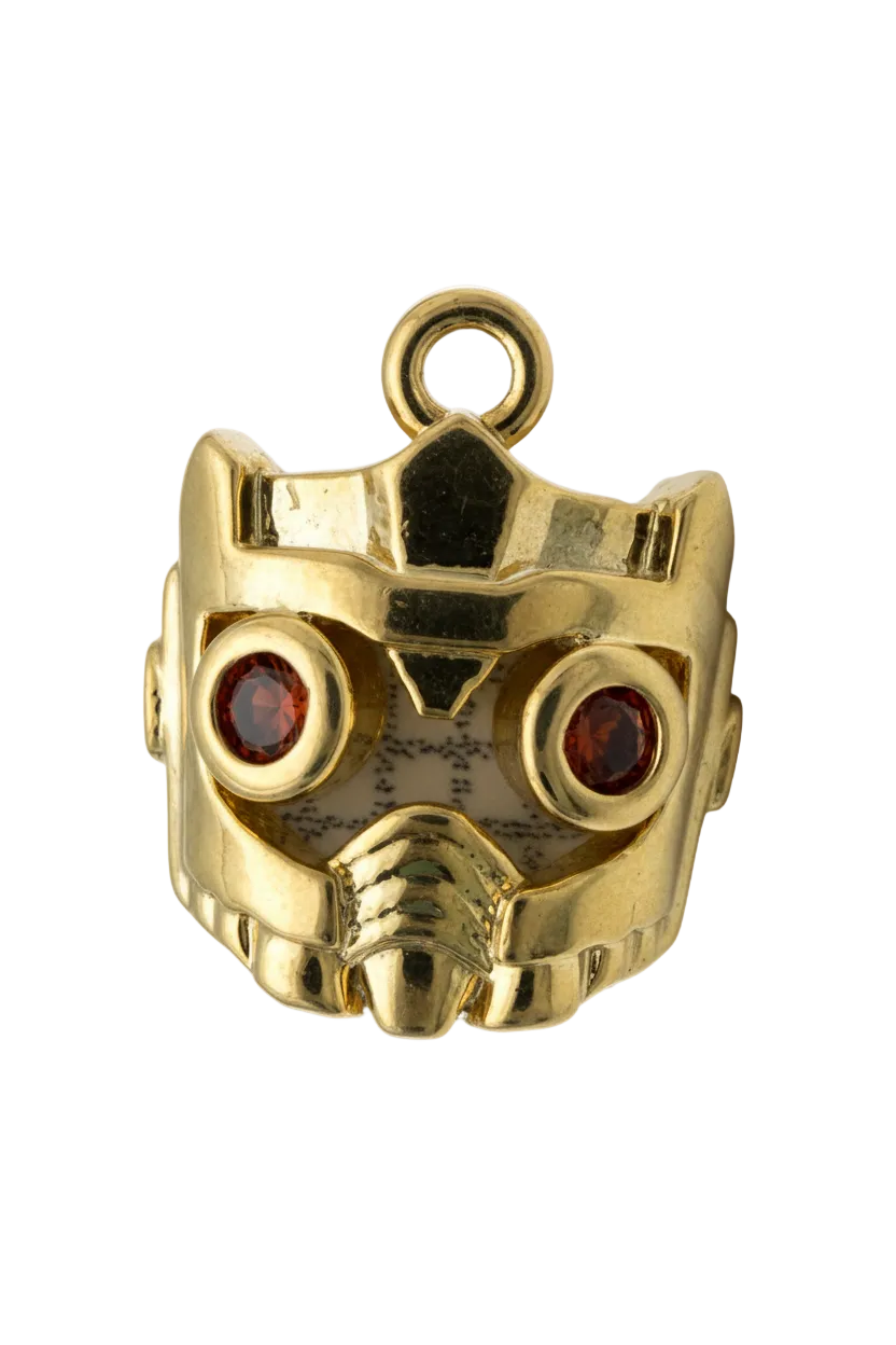 Polished gold skull head with two red gem eyes