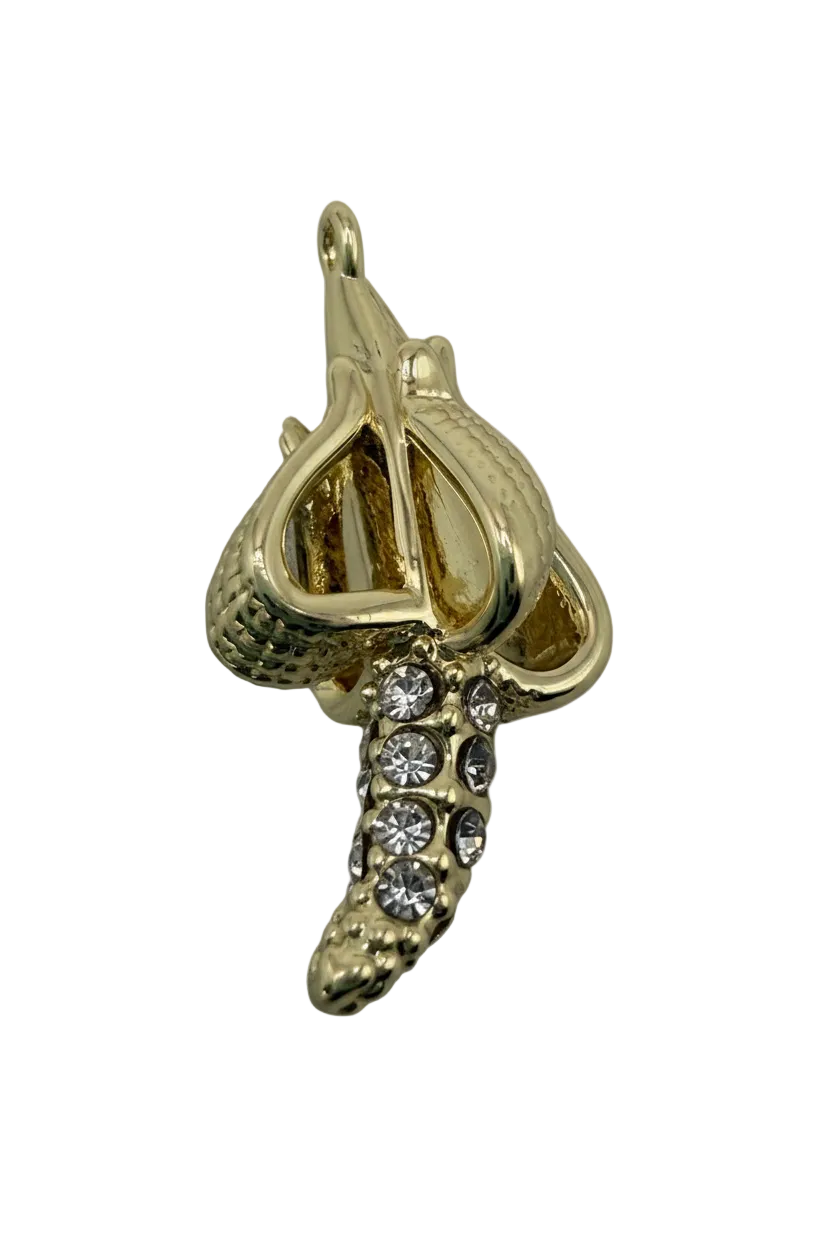 Gold banana charm with clear crystal accents and textured peel detail on a black background