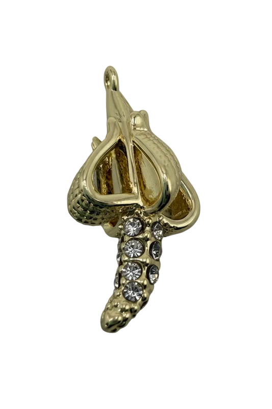Gold banana charm with clear crystal accents and textured peel detail on a black background