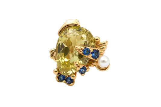 Gold turtle charm with faceted yellow gem shell and blue gem accents