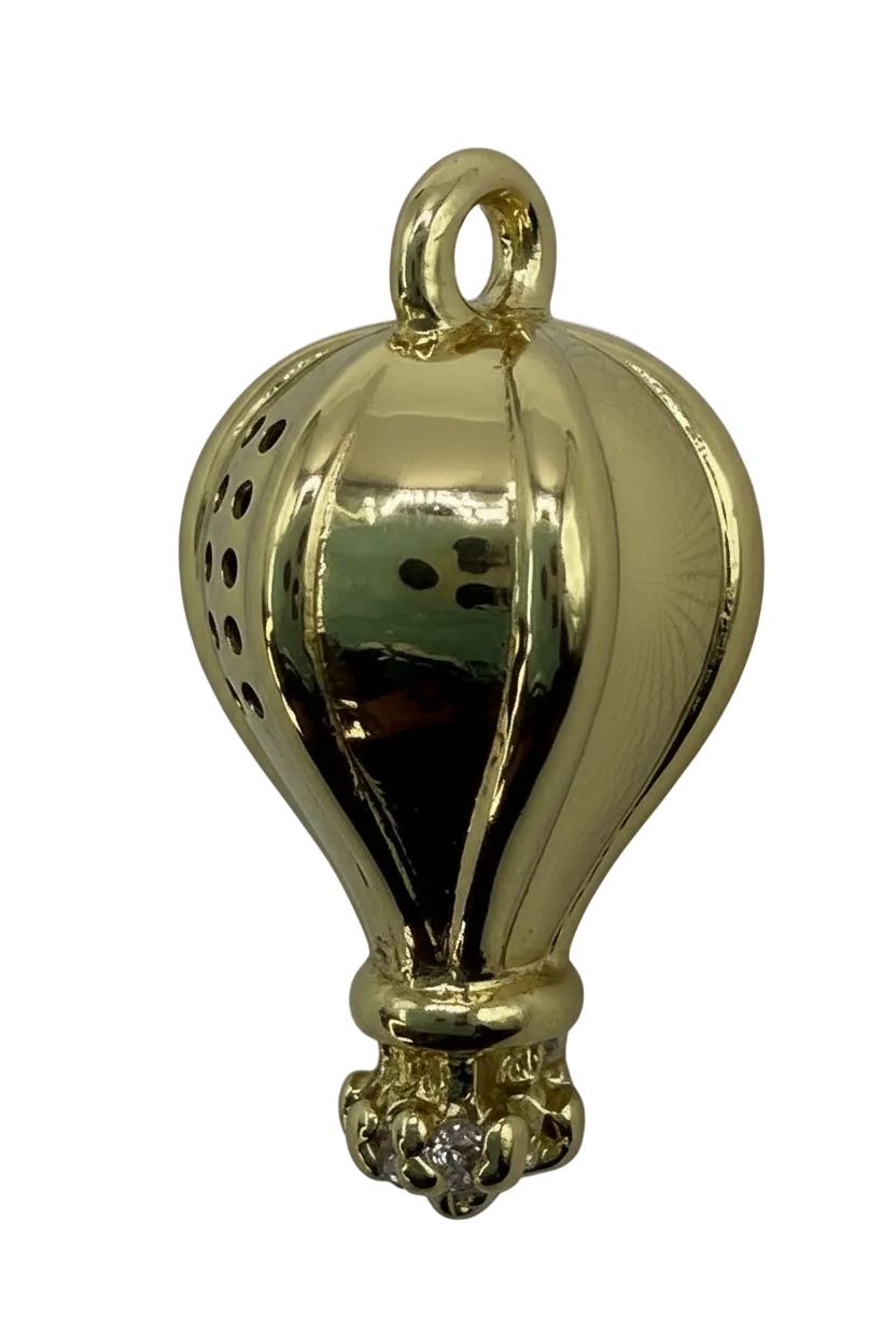 High-polish gold seashell pendant with sculpted ridges on black background