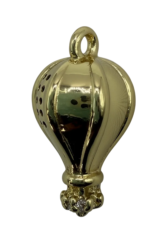 High-polish gold seashell pendant with sculpted ridges on black background