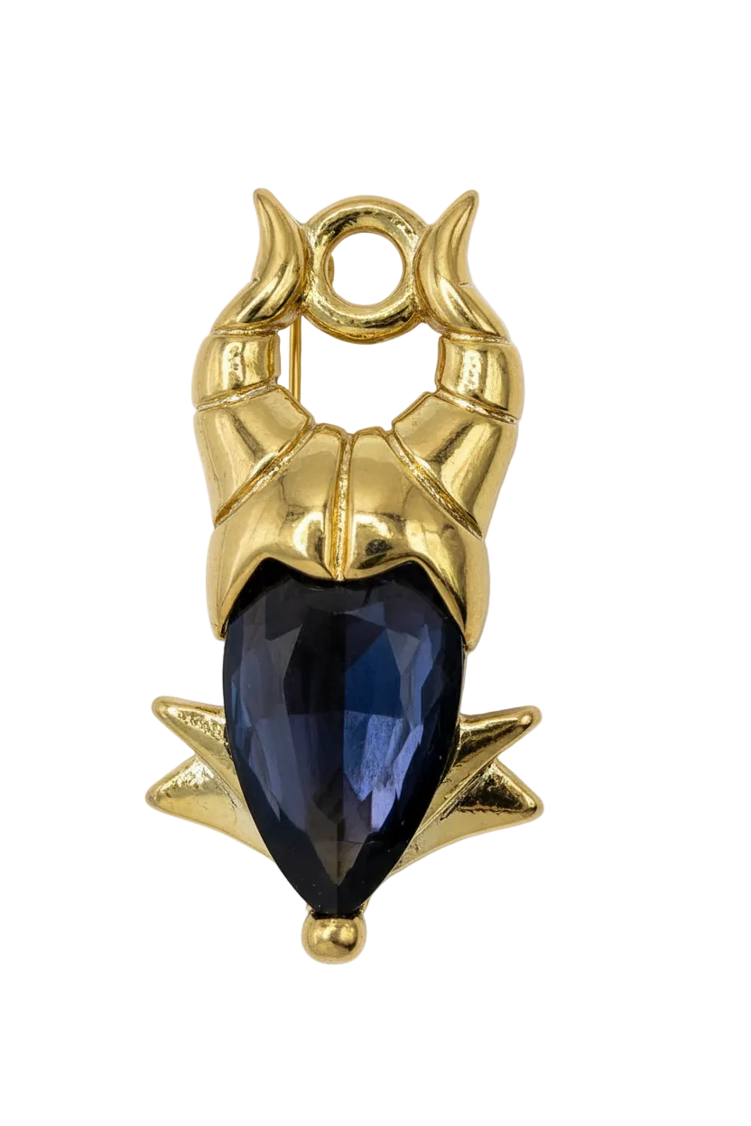 Gold owl totem with a faceted black gem center and ivory detailing