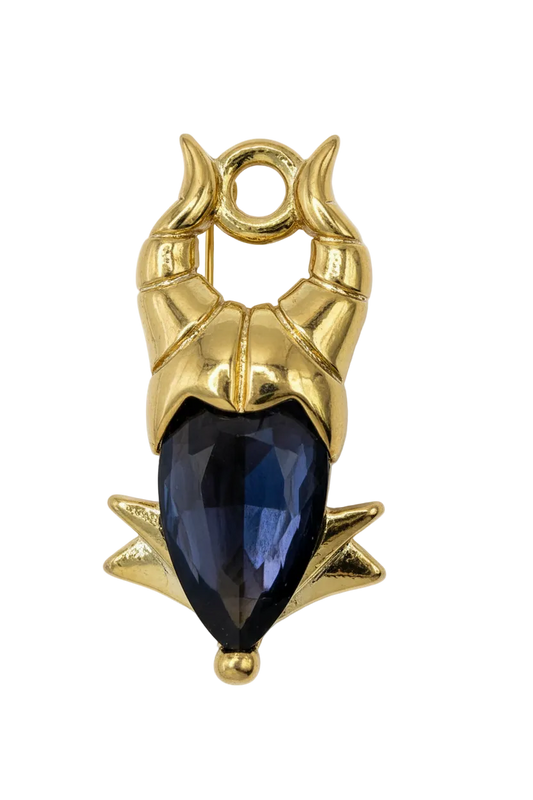 Gold owl totem with a faceted black gem center and ivory detailing