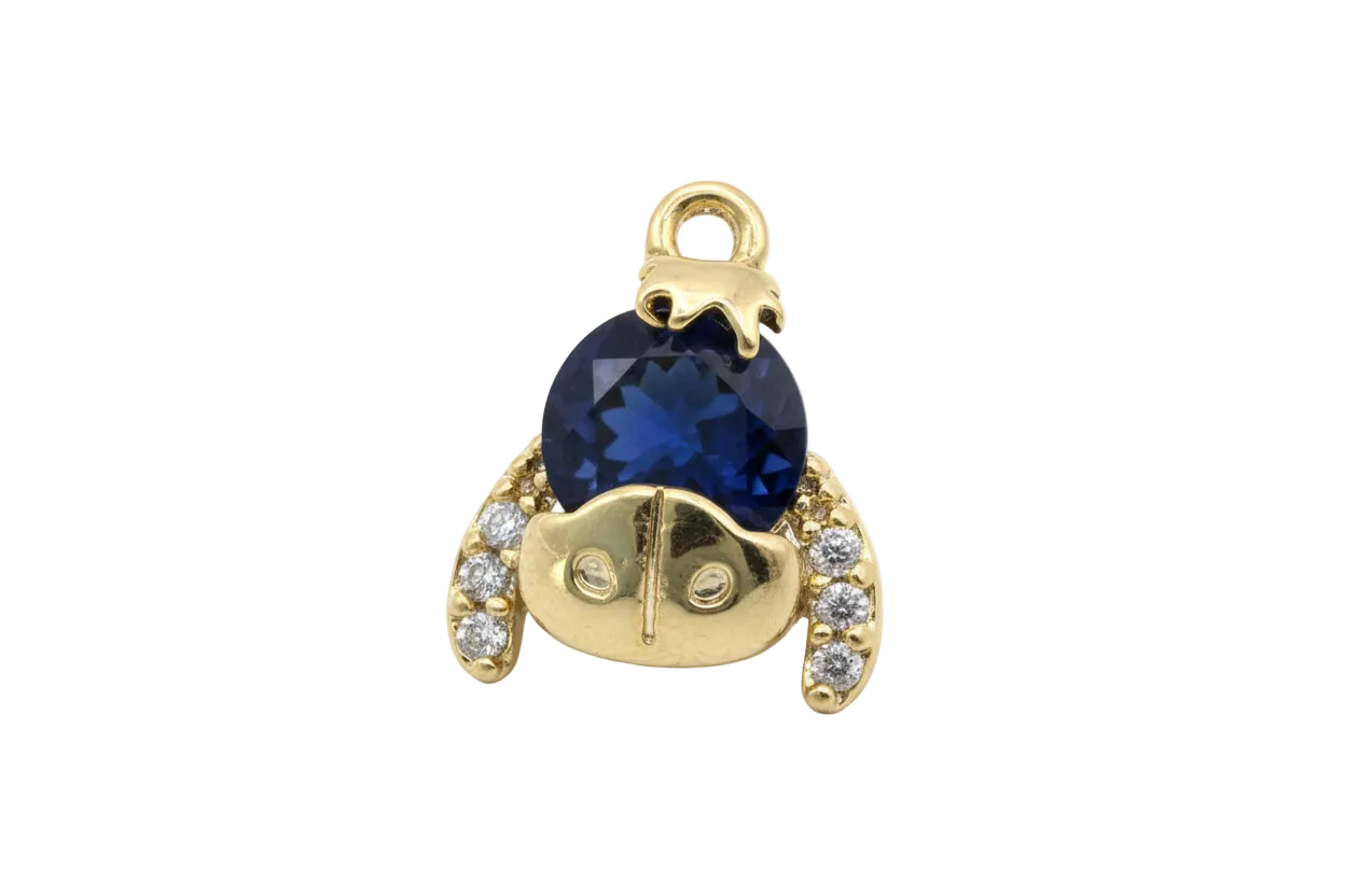 Gold bear motif with faceted midnight-blue round gem and clear crystal accents