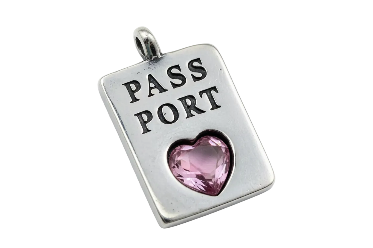 Silver-tone passport plate with engraved text and a faceted pink heart gem