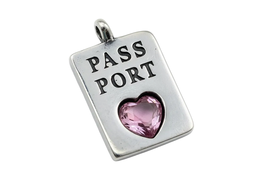 Silver-tone passport plate with engraved text and a faceted pink heart gem
