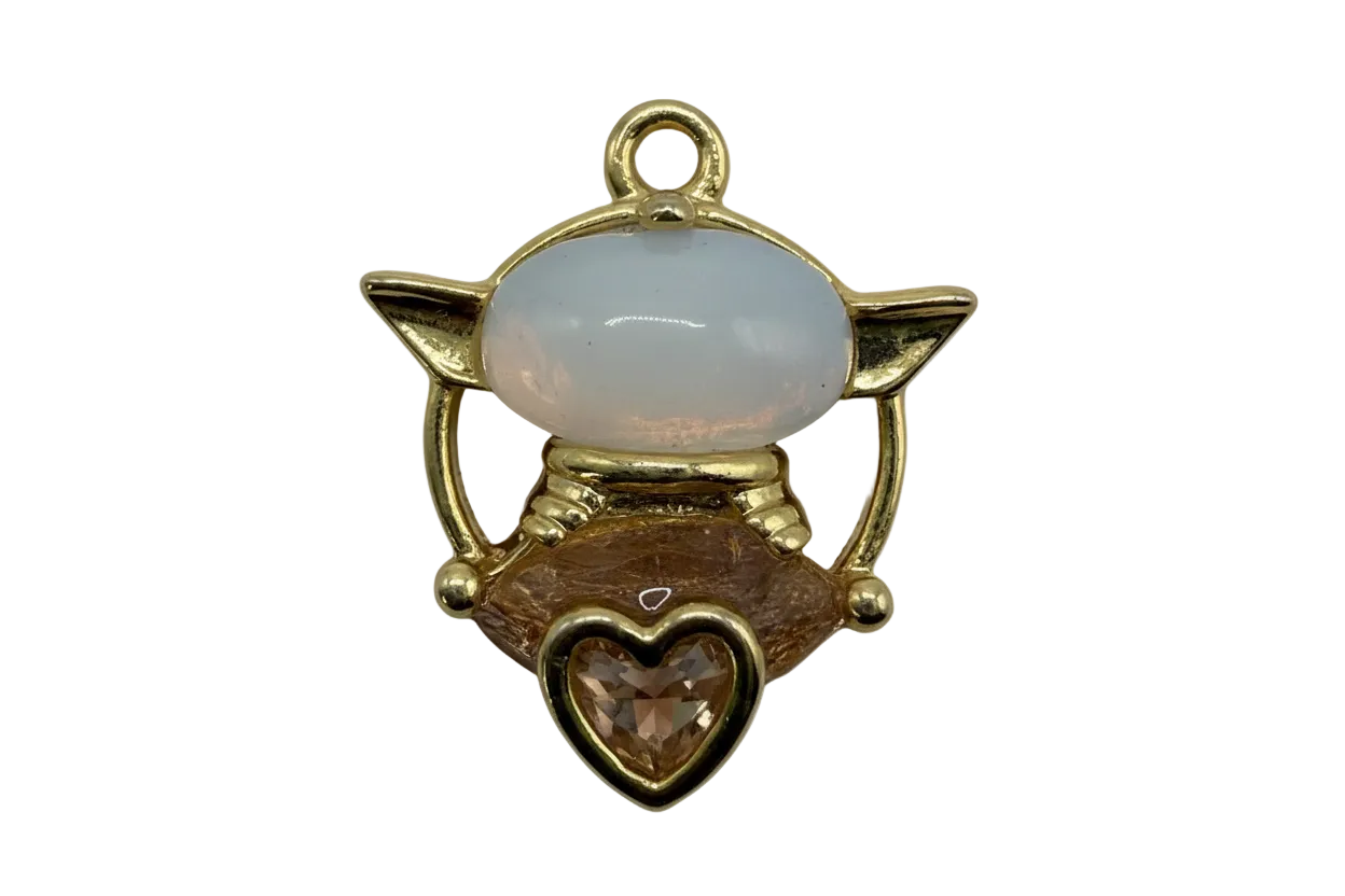 Gold winged cat charm with glossy white enamel face and honey amber heart gem