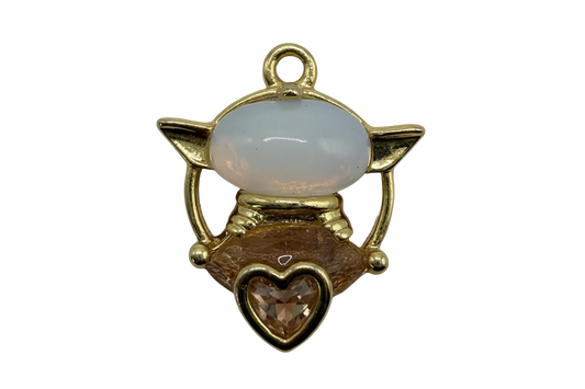 Gold winged cat charm with glossy white enamel face and honey amber heart gem