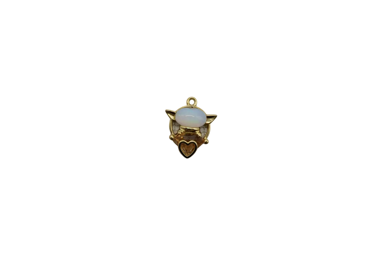 Gold winged cat with white enamel and honey heart gem