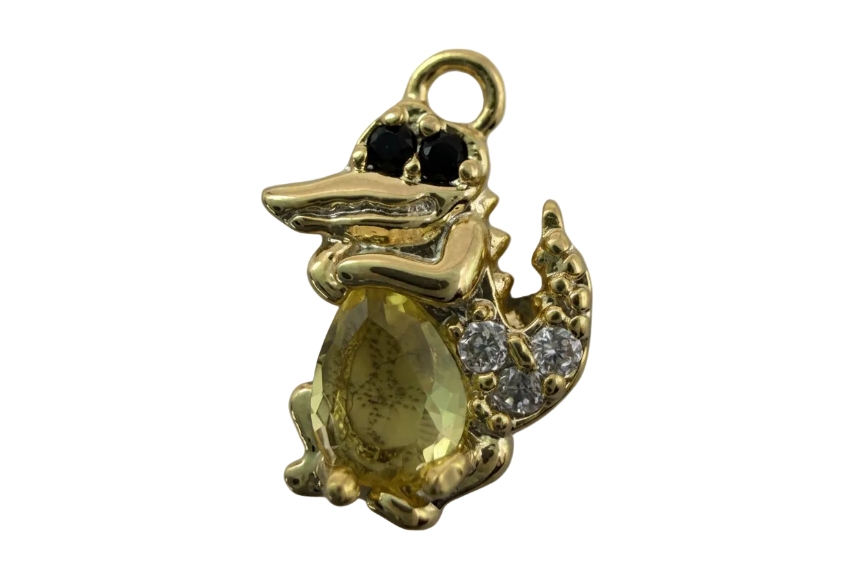 Gold crocodile figure with faceted yellow oval gem, black eyes, and clear crystal accents