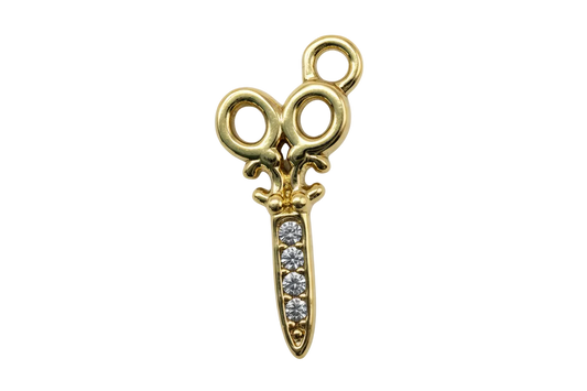 Gold scissors motif with clear crystal gems set along the blade