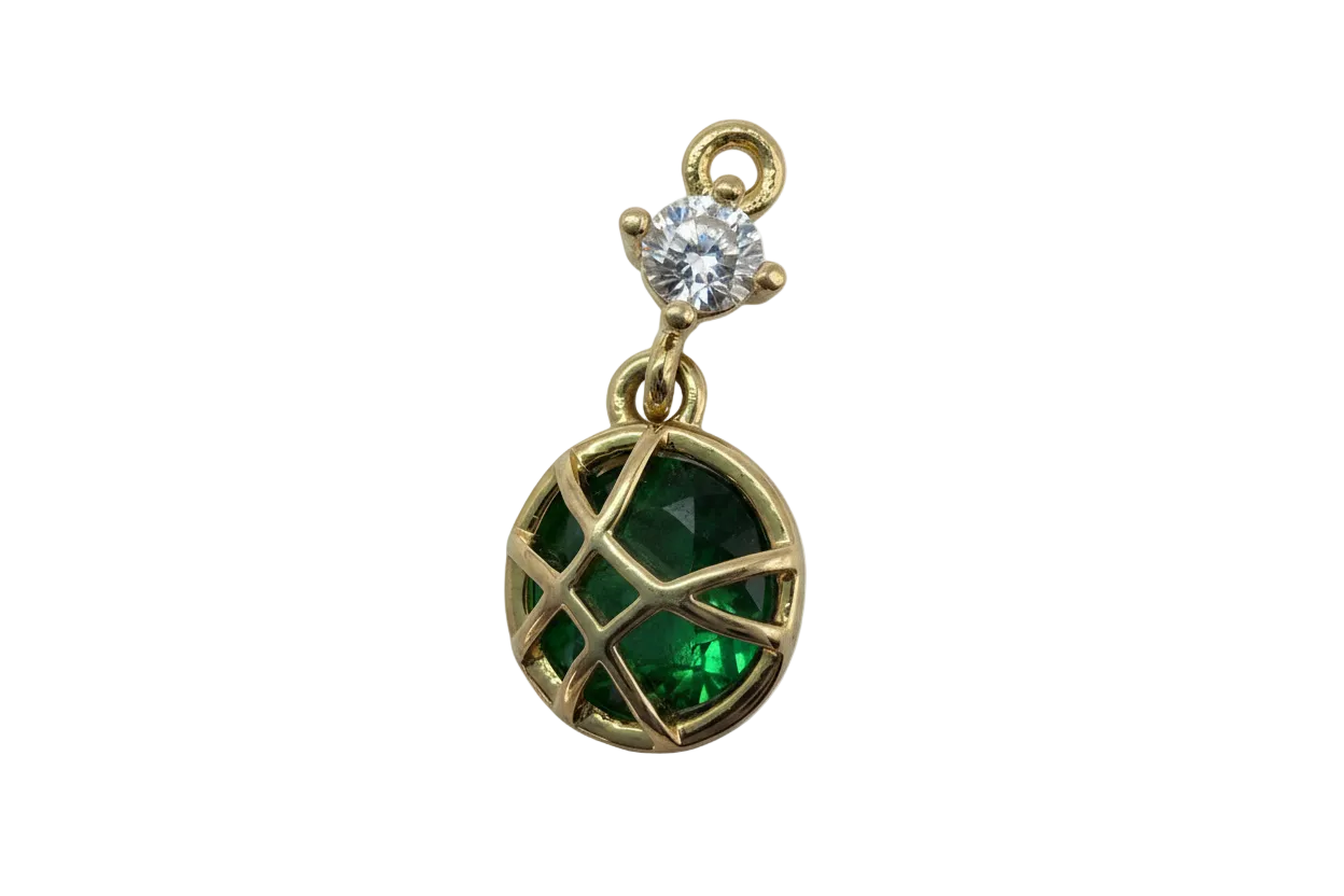 Gold lattice charm with faceted emerald green round gem and small clear gem accent