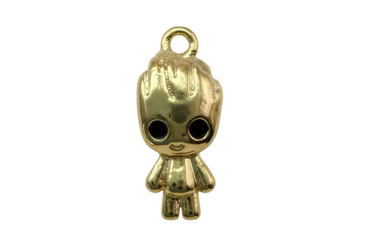 High-polish gold doll figure with oversized black eyes and textured hair