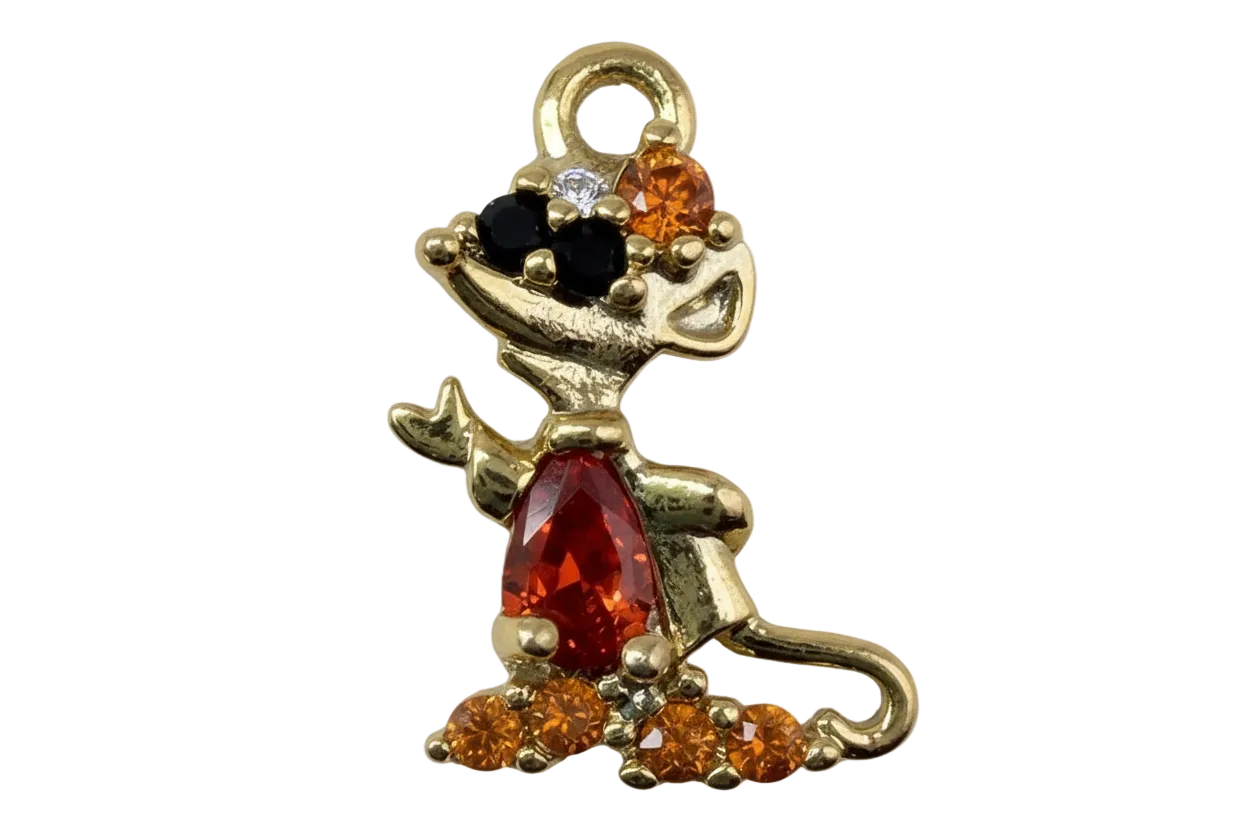 Gold sitting dog figure with red center gem, amber crystals, and black accents