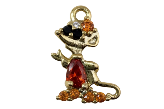 Gold sitting dog figure with red center gem, amber crystals, and black accents