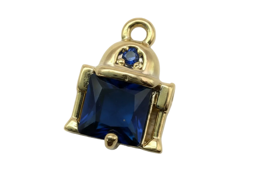 Gold-framed faceted navy square gem with small navy accent stone