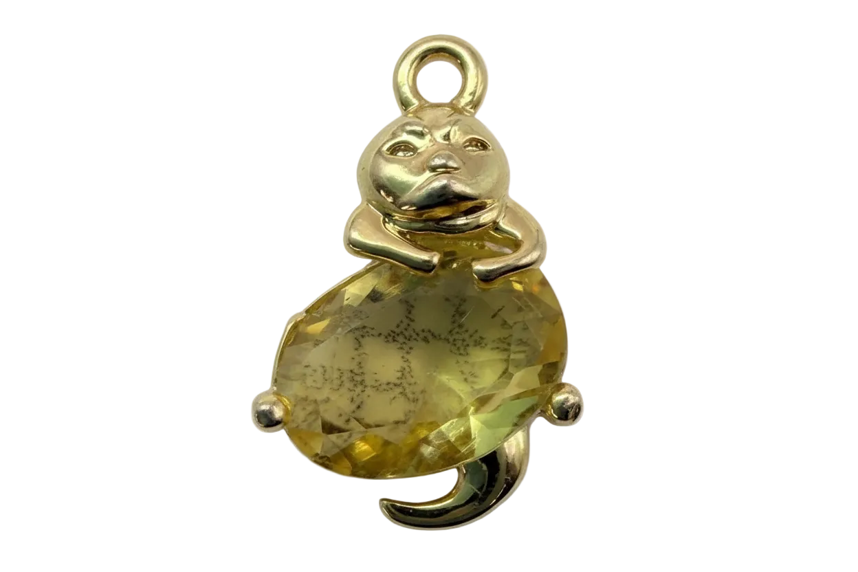 Polished gold teddy bear figure hugging a faceted yellow gem with subtle smoky marbling