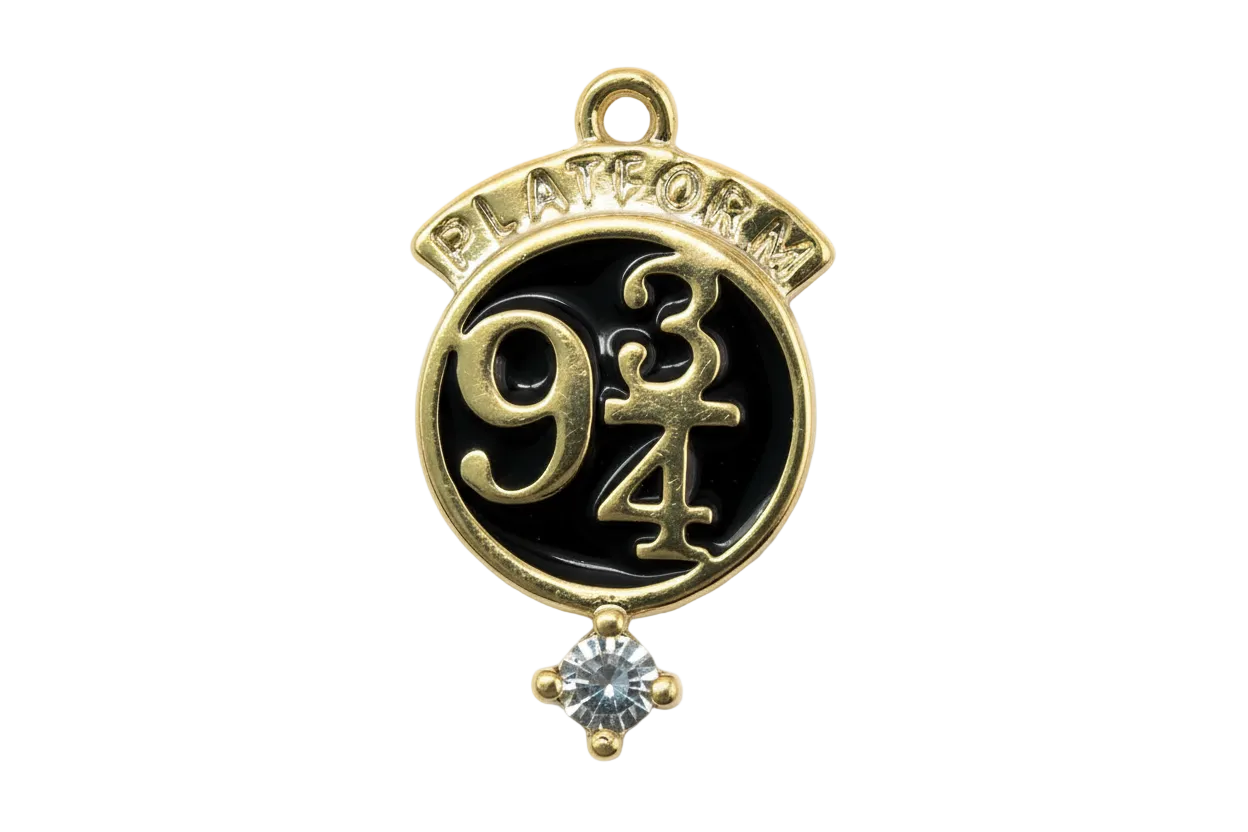 Gold round medallion with black enamel, raised “9 3/4” design, and clear crystal accent