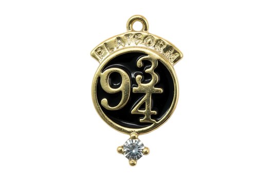 Gold round medallion with black enamel, raised “9 3/4” design, and clear crystal accent