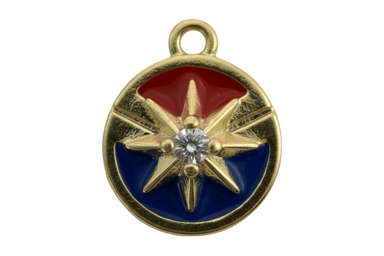 Round gold compass rose medallion with red and blue enamel and a clear center gem