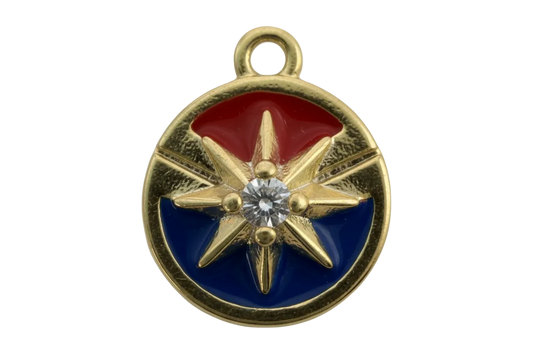 Round gold compass rose medallion with red and blue enamel and a clear center gem