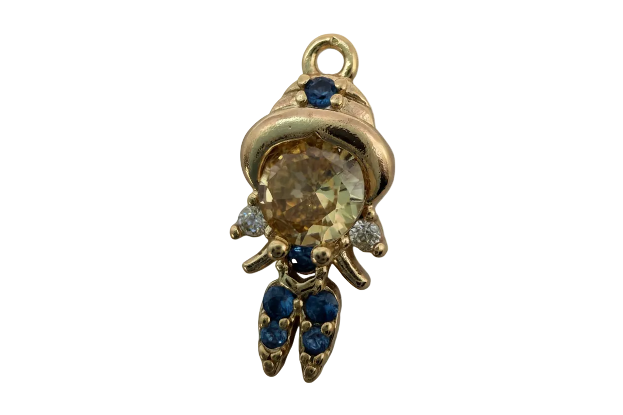 Gold astronaut figure with champagne faceted gem center and blue and clear gem accents