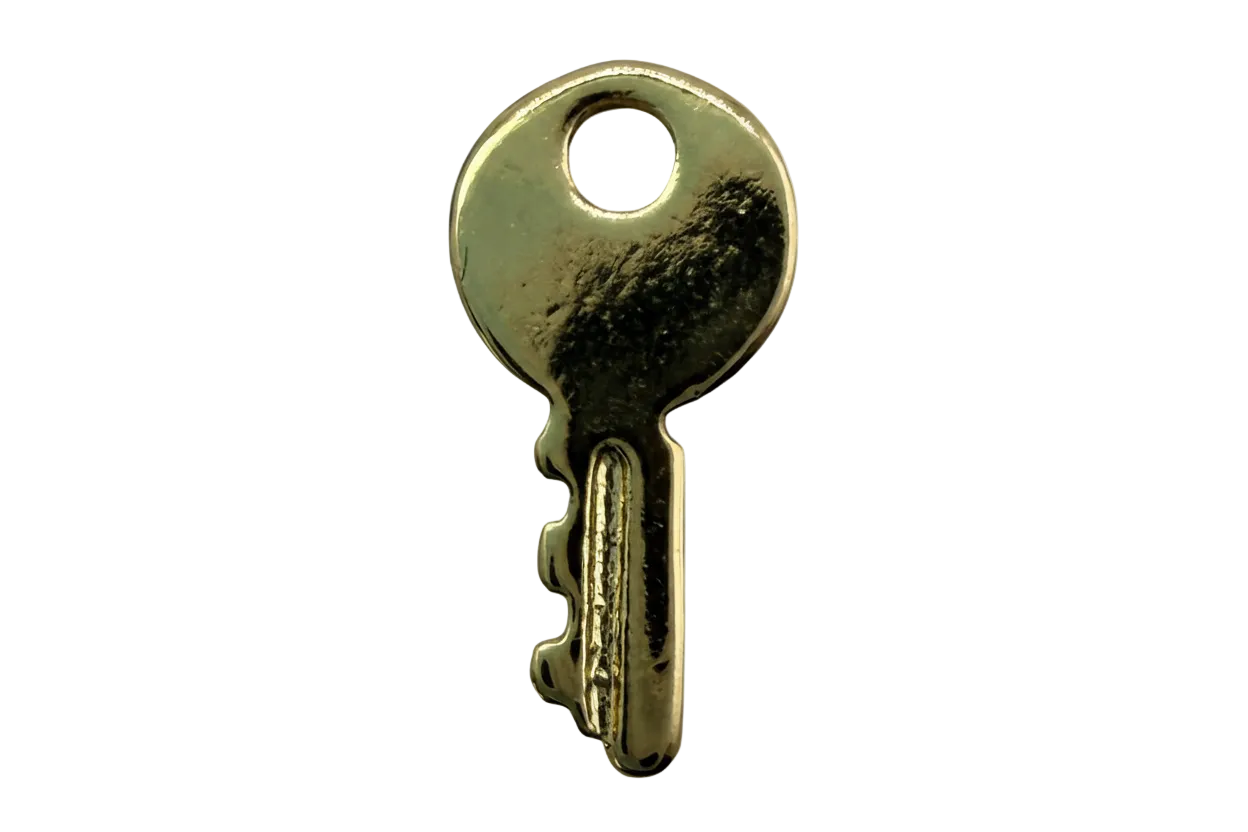 Polished gold key charm with a small round white marbled gem accent
