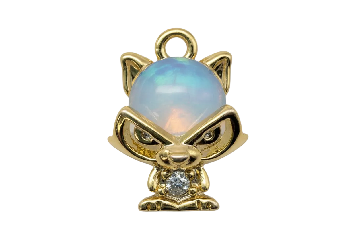 Gold cat figurine with opalescent blue dome and clear gem accent