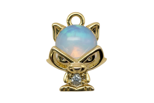 Gold cat figurine with opalescent blue dome and clear gem accent