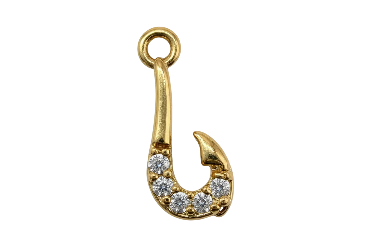 Gold safety pin charm with pavé clear crystals on a black background