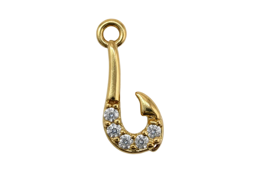 Gold safety pin charm with pavé clear crystals on a black background