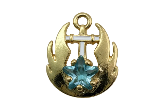 Gold anchor medallion with white enamel pattern and faceted aqua star gem