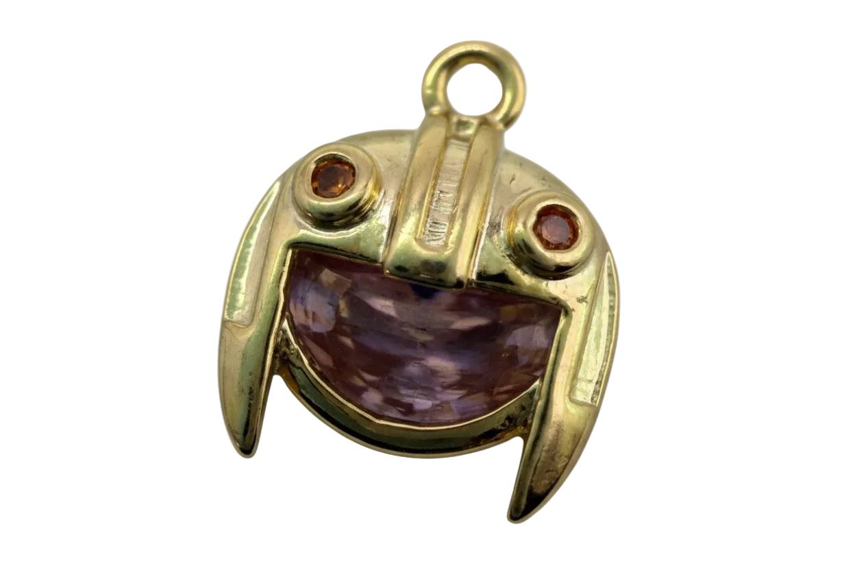 Gold frog face charm with marbled purple inlay and red and opalescent eye gems