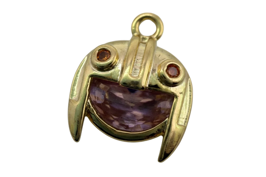 Gold frog face charm with marbled purple inlay and red and opalescent eye gems